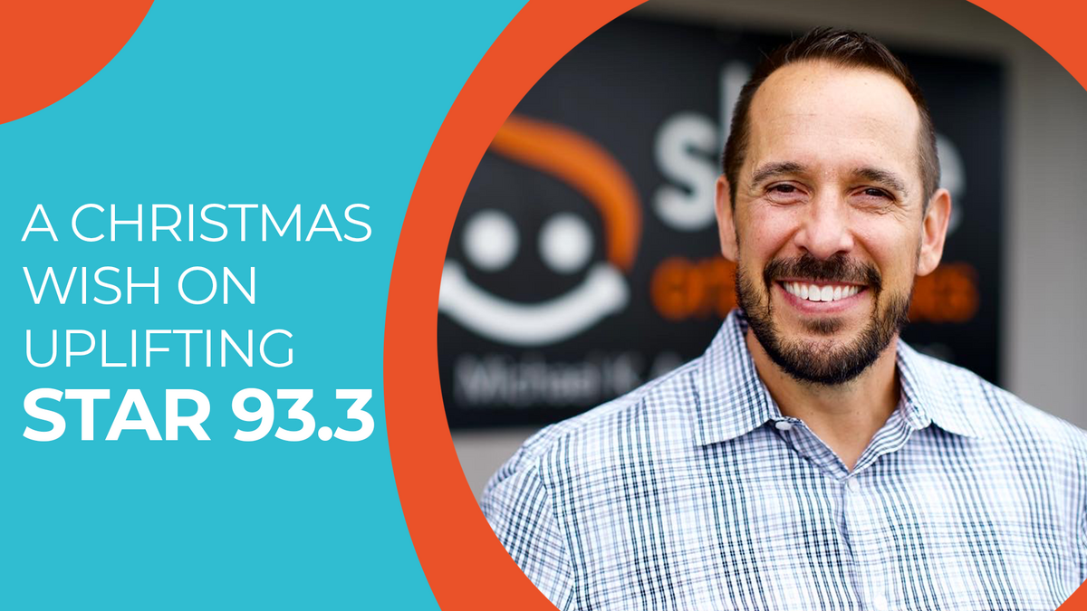 Man smiling with text "A Christmas Wish On Uplifting STAR 93.3"